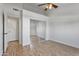 Bright bedroom with ceiling fan, sliding closet, and wood look tile flooring at 20352 N 109Th Dr, Peoria, AZ 85373