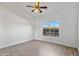 Bright bedroom with a ceiling fan, window, and wood look tile flooring at 20352 N 109Th Dr, Peoria, AZ 85373