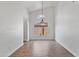 Empty dining room with tile floors, a modern chandelier, and white walls at 20352 N 109Th Dr, Peoria, AZ 85373