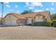 Beautiful single-story home featuring a tile roof, desert landscaping, and a spacious two-car garage at 20352 N 109Th Dr, Peoria, AZ 85373