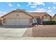 Charming single-story home featuring a tile roof, two-car garage, and low-maintenance gravel landscaping at 20352 N 109Th Dr, Peoria, AZ 85373