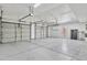 Spacious three car garage providing ample parking and storage space, featuring white doors and bright lighting at 20352 N 109Th Dr, Peoria, AZ 85373