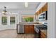 Bright kitchen featuring stainless steel appliances, granite countertops, and natural wood cabinetry at 20352 N 109Th Dr, Peoria, AZ 85373