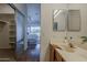 Bathroom featuring a double sink vanity, framed mirrors, and natural lighting and a sliding closet door at 205 N 74Th St # 261, Mesa, AZ 85207