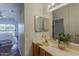 Bathroom featuring a double sink vanity, framed mirrors, and natural lighting at 205 N 74Th St # 261, Mesa, AZ 85207