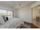 Bright bedroom with a private balcony featuring a large bed and wood-look flooring at 205 N 74Th St # 261, Mesa, AZ 85207
