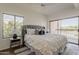 Bedroom with soft natural light, neutral color palette, and balcony access overlooking a wooded area at 205 N 74Th St # 261, Mesa, AZ 85207