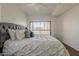 Bright bedroom features a large bed with gray accents and a private balcony overlooking greenery at 205 N 74Th St # 261, Mesa, AZ 85207