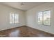 Bedroom features hardwood floors, ceiling fan, and views of the community at 205 N 74Th St # 261, Mesa, AZ 85207