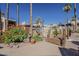 Beautifully landscaped community with flower beds and palm trees at 205 N 74Th St # 261, Mesa, AZ 85207