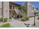 Inviting condo exterior with lush landscaping, stairway, and a charming bicycle display at 205 N 74Th St # 261, Mesa, AZ 85207