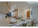 Bright kitchen with stainless steel sink, light wood cabinets, and a breakfast bar with seating at 205 N 74Th St # 261, Mesa, AZ 85207