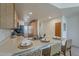 Bright kitchen with stainless steel sink, light wood cabinets, and a breakfast bar with seating at 205 N 74Th St # 261, Mesa, AZ 85207