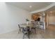 Dining area with adjacent kitchen, featuring bar seating, modern appliances, and wood cabinetry at 205 N 74Th St # 261, Mesa, AZ 85207
