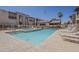 Community pool with plenty of lounge chairs for relaxing and enjoying the sun at 205 N 74Th St # 261, Mesa, AZ 85207