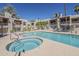 Sparkling community pool and hot tub with plenty of lounge chairs at 205 N 74Th St # 261, Mesa, AZ 85207
