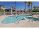 Community pool and hot tub surrounded by palm trees with lounge chairs at 205 N 74Th St # 261, Mesa, AZ 85207