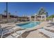 Community pool area with shaded seating, lounge chairs, and desert landscaping at 205 N 74Th St # 261, Mesa, AZ 85207