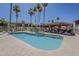 Community pool area with shaded seating, lounge chairs, and mature palm trees at 205 N 74Th St # 261, Mesa, AZ 85207