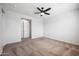 Comfortable bedroom featuring a ceiling fan and carpeted floor at 21075 E Estrella Rd, Queen Creek, AZ 85142