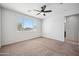 Bright bedroom features a ceiling fan and a window with outdoor view at 21075 E Estrella Rd, Queen Creek, AZ 85142