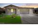 Charming single-story home featuring a two-car garage, manicured lawn, and desert landscaping at 21075 E Estrella Rd, Queen Creek, AZ 85142