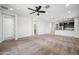 Bright, open living room with ceiling fan flowing into a modern kitchen with stainless appliances at 21075 E Estrella Rd, Queen Creek, AZ 85142