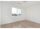 Bright bedroom featuring hardwood floors, a large window, and white walls and trim at 2130 E Turney Ave # 4, Phoenix, AZ 85016
