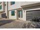 Modern townhouse facade with a gray garage door, white stucco, and clean architectural lines at 2130 E Turney Ave # 4, Phoenix, AZ 85016