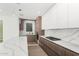 Modern kitchen showcasing a large island with waterfall countertops, stylish cabinetry, and stainless steel appliances at 2130 E Turney Ave # 4, Phoenix, AZ 85016