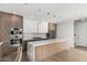 Well-appointed kitchen boasts a large island, modern cabinetry, designer lighting, and stainless steel appliances at 2130 E Turney Ave # 4, Phoenix, AZ 85016
