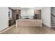 Modern kitchen features a spacious island, marble countertops, custom cabinets, and stainless steel appliances at 2130 E Turney Ave # 4, Phoenix, AZ 85016