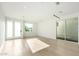 Spacious living room showcases hardwood floors, white walls, and natural light from large windows and sliding doors at 2130 E Turney Ave # 4, Phoenix, AZ 85016