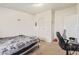 Small, basic bedroom includes a bed, desk, window, and minimal decor at 22216 W Bajada Dr, Wittmann, AZ 85361