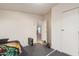 Modest bedroom with bare walls, closet, and doorway offering a glimpse into another room at 22216 W Bajada Dr, Wittmann, AZ 85361