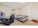 A small, disorganized bedroom with a desk, bed, and various items scattered around the room at 22216 W Bajada Dr, Wittmann, AZ 85361