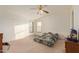 An airy bedroom with two windows, neutral carpet, ceiling fan, and potential for personalization at 22216 W Bajada Dr, Wittmann, AZ 85361