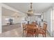 Dining space with wood table, chairs, wood flooring, and access to both the living room and kitchen at 22216 W Bajada Dr, Wittmann, AZ 85361
