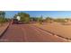 Gravel driveway leading to a quaint single story home surrounded by desert landscaping at 22216 W Bajada Dr, Wittmann, AZ 85361