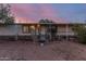 Home exterior with covered porch and desert landscaping for a serene outdoor experience at 22216 W Bajada Dr, Wittmann, AZ 85361