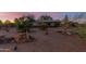 Exterior of ranch home featuring mature landscape, and address stone in a desert environment at 22216 W Bajada Dr, Wittmann, AZ 85361