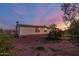 Well-kept home with charming exterior and a beautifully landscaped surrounding at sunset at 22216 W Bajada Dr, Wittmann, AZ 85361
