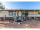 Cozy exterior view of a charming home featuring neutral siding, a covered porch, and desert landscaping at 22216 W Bajada Dr, Wittmann, AZ 85361