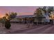 Desert home featuring a large yard, mature trees, and a covered porch to enjoy sunsets at 22216 W Bajada Dr, Wittmann, AZ 85361