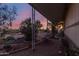 Inviting front porch view with custom landscaping, offering a serene outdoor space with beautiful sunset skies at 22216 W Bajada Dr, Wittmann, AZ 85361