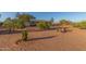 Expansive front yard features desert landscaping, a gravel driveway, and ample space at 22216 W Bajada Dr, Wittmann, AZ 85361