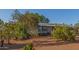 Expansive front yard features desert landscaping, gravel, a charming home, and ample space at 22216 W Bajada Dr, Wittmann, AZ 85361