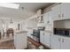 Functional kitchen featuring white cabinetry, black appliances, and a view into the dining area at 22216 W Bajada Dr, Wittmann, AZ 85361