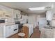 A kitchen with stainless steel appliances and white cabinets featuring a skylight for natural light at 22216 W Bajada Dr, Wittmann, AZ 85361