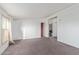 Neutral living space boasting carpet floors, white walls, and bright natural light from a window at 22216 W Bajada Dr, Wittmann, AZ 85361